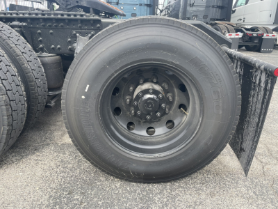 Mack PR64T76H truck wheel and tire assembly showing solid steel wheel with hub and lug nuts.