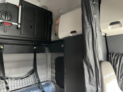 Freightliner Cascadia 126 truck interior sleeper area with storage cabinet, bunk area, and cab upholstery visible