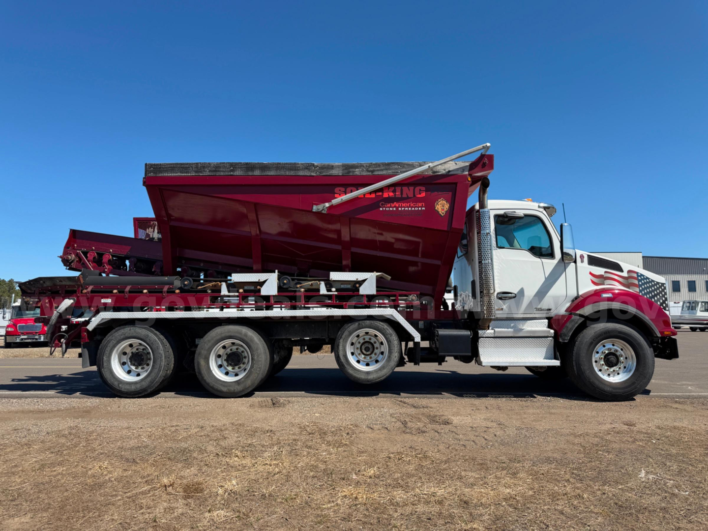 Kenworth T880 side view dump truck with red dump bed and white cab, asphalt/oil delivery equipment, VIN JJ221980, stock 24329-491.