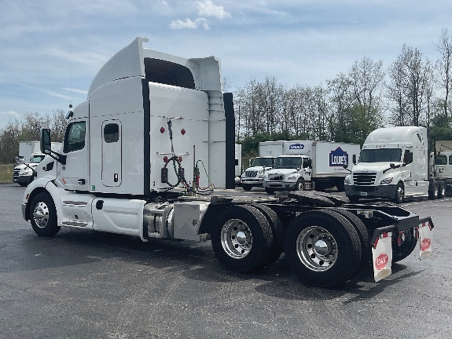 Peterbilt 579 UltraCab tractor truck side view showing rear chassis and dual rear axles with fifth wheel, white cab, no trailer