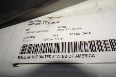 Label view showing VIN and model info for 2014 International PROSTAR+ 122: NAVISTAR, INC., WARRENVILLE, IL USA; MODEL PROSTAR+ 122 6x4; VIN 1HSDJAPR8EH798059; DATE MFG 07-2013; 485.0 cm 191.0 in wheelbase; MADE IN THE UNITED STATES OF AMERI