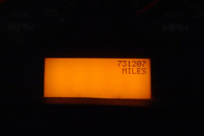 Dashboard display showing odometer reading 731207 MILES in orange LCD.