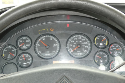 Dashboard view of a 2014 International Prostar+ 122 with multiple gauges including RPM, speedometer, fuel, and warning lights.