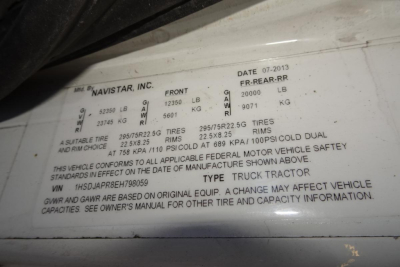 Label showing vehicle data on International ProStar+ 122: date 07-2013, front axle 12500 lb, rear 20000 lb, GVWR 25950 lb, gross and payload specs, VIN 1HSDJAPR8EH798059, Navistar Inc., front and rear tire info, cold dual tires, tire sizes 