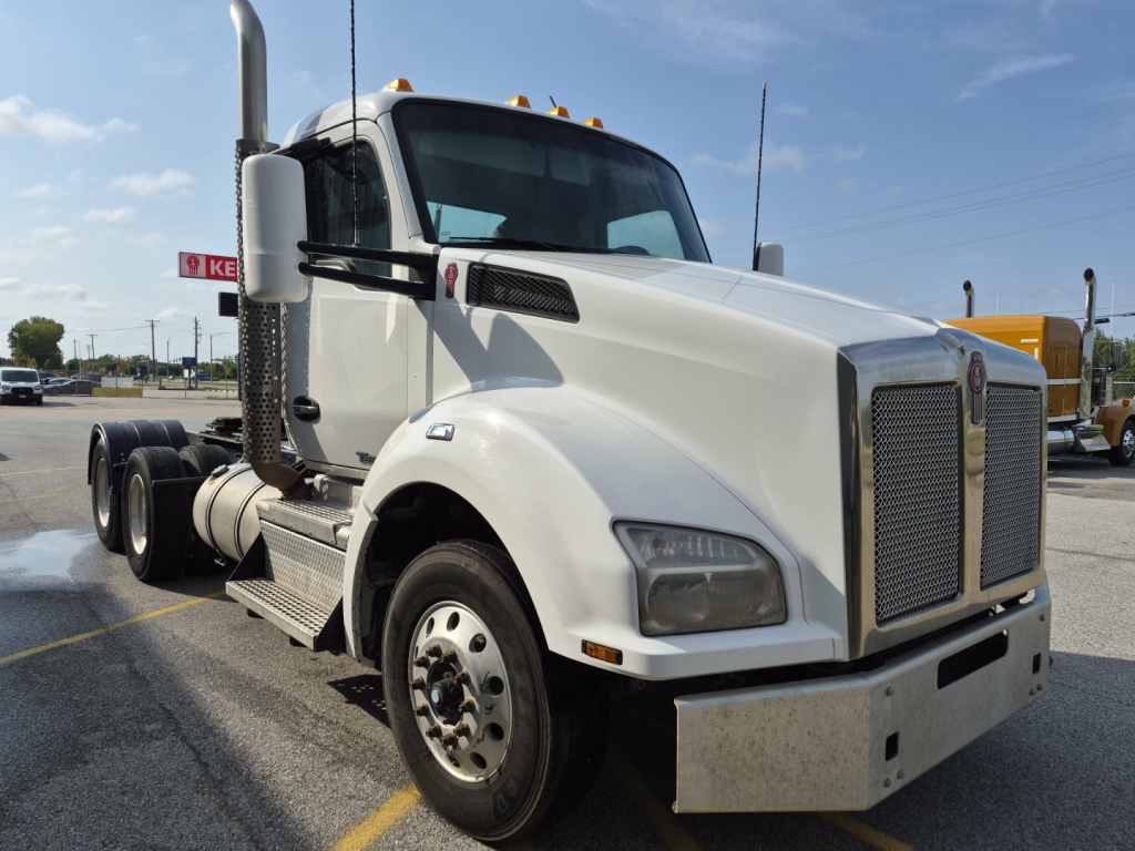 Kenworth T880 cab-over/tractor in white, front-left view with chrome grille, large bumper, dual rear axles, and side steps.