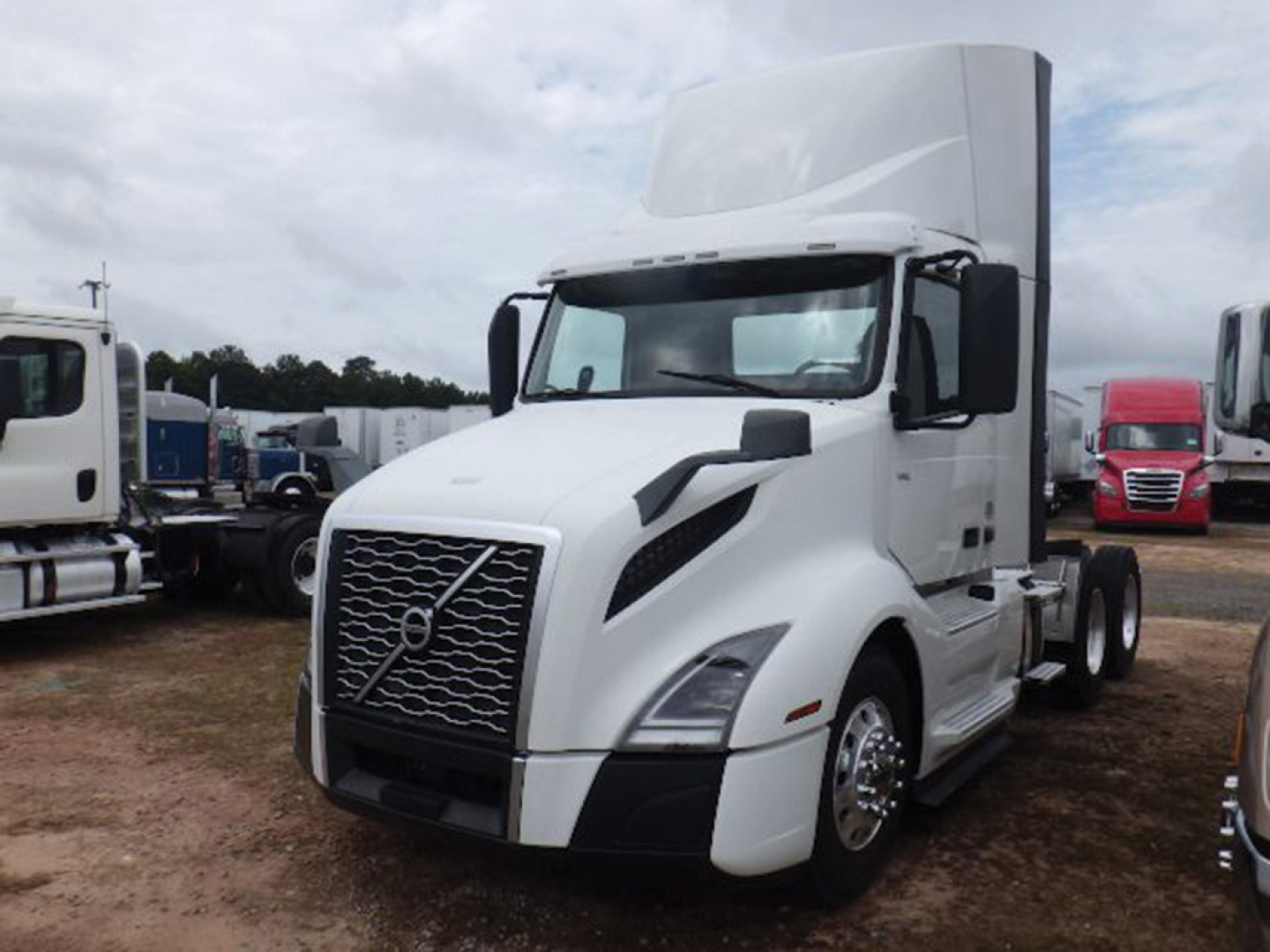 Volvo VNL 300 cab and sleeper tractor truck in white, front grille with Volvo emblem, large mirrors, daytime running lights; tall sleeper and elevated roof.