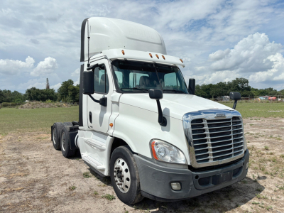 Truck cab front-left view of a white 2016 Freightliner Cascadia Evolution tractor with aerodynamic sleeper and chrome grille.