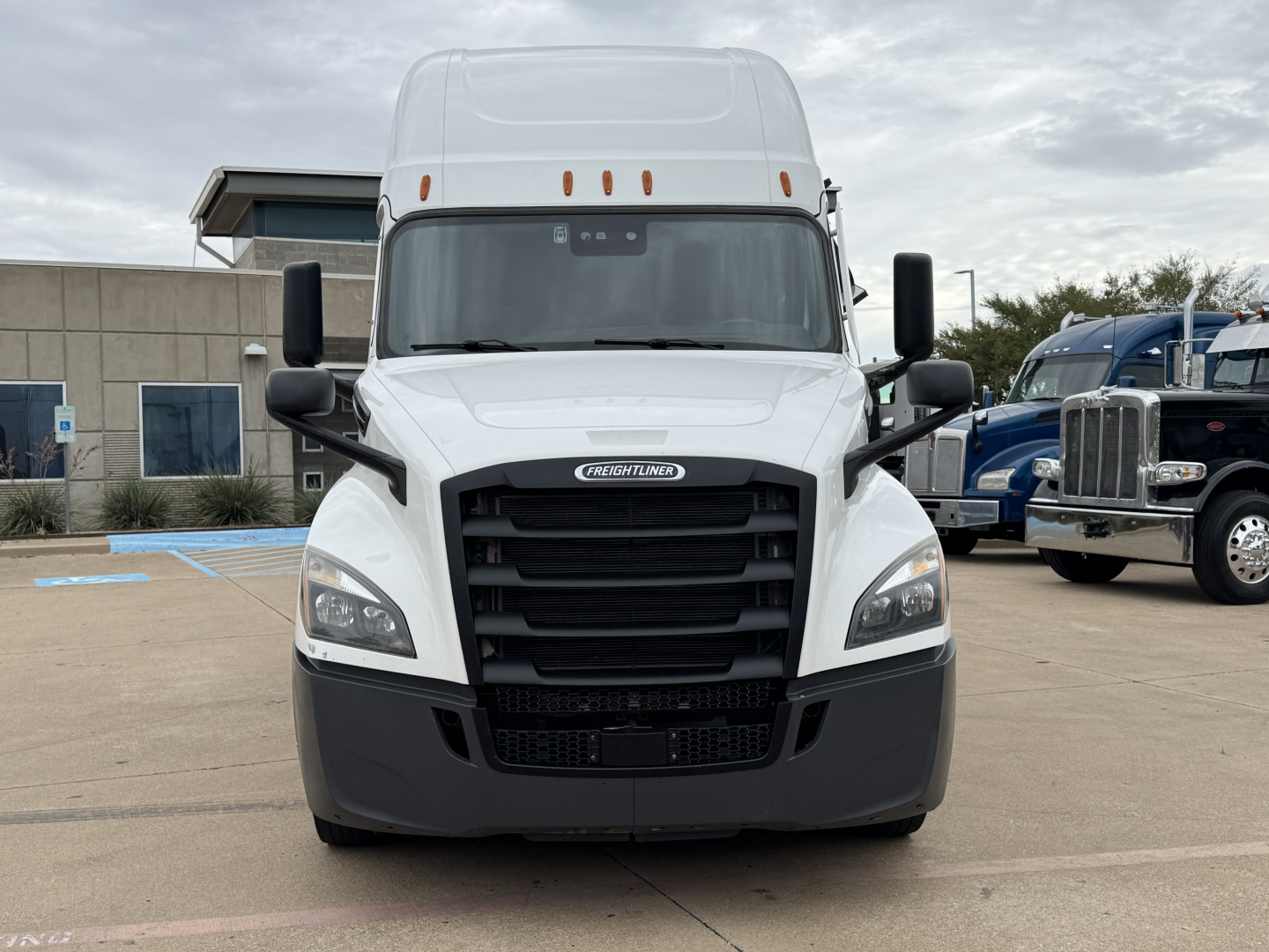 Freightliner PT126064ST truck front view showing grille, headlights, mirrors, and bumper.