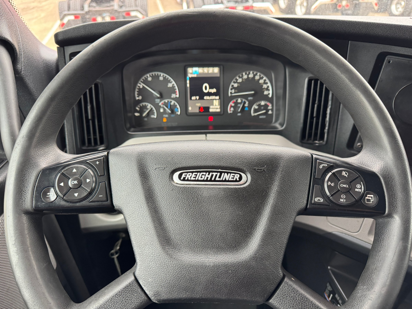 Freightliner steering wheel and dashboard view from the driver's seat in a 2021 Freightliner PT126064ST truck showing instrument cluster and controls.