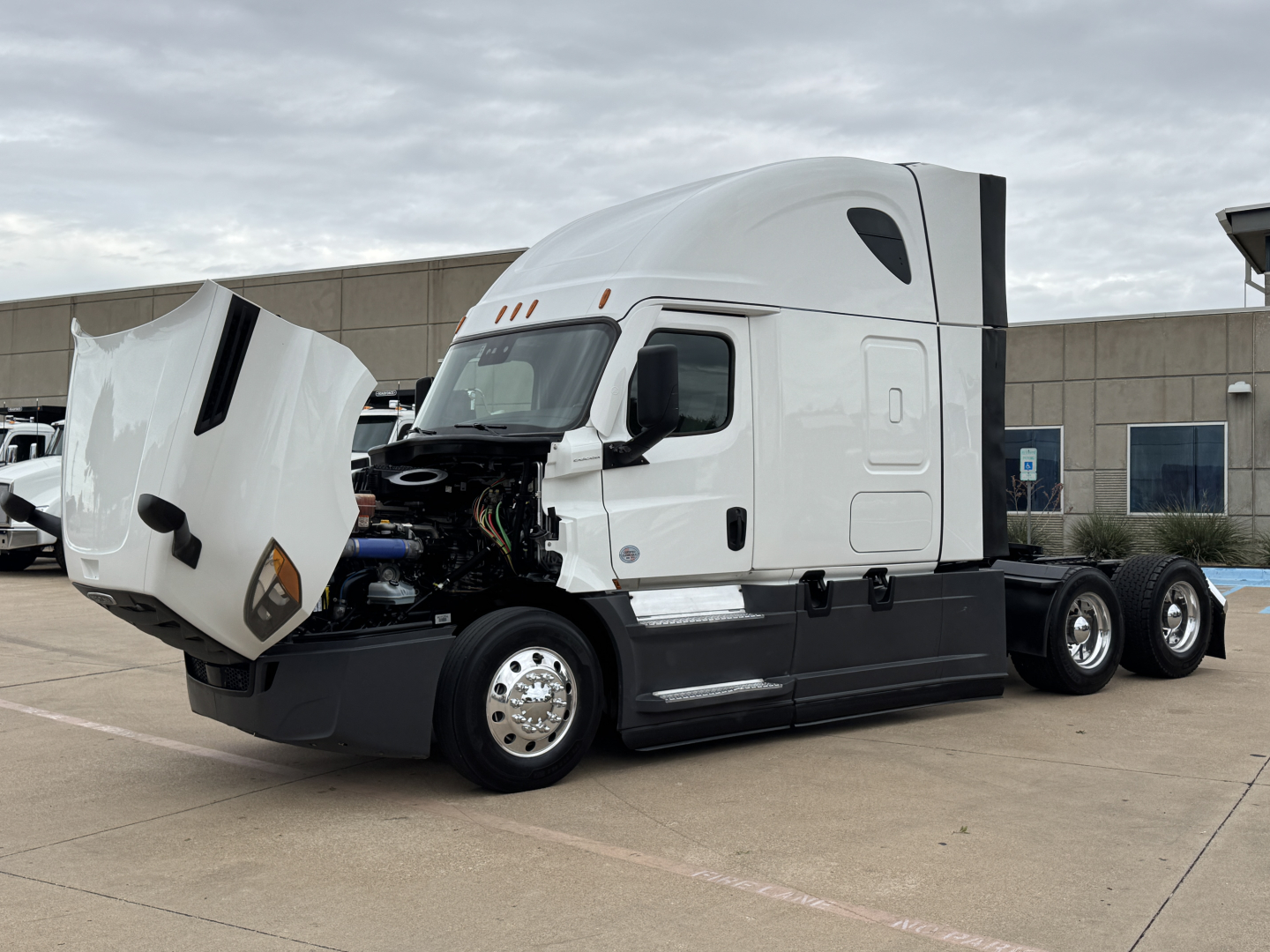 Freightliner PT126064ST tractor with hood open showing engine bay and front half of cab.