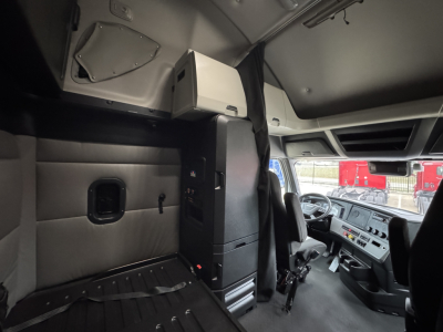 Cab interior of Freightliner PT126064ST showing dash area and sleeper cabin partitions.
