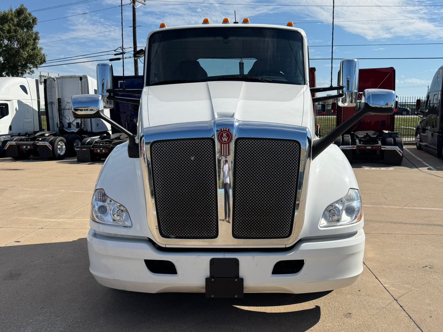 Kenworth T680 front view showing large chrome grille, headlights, and Kenworth emblem.