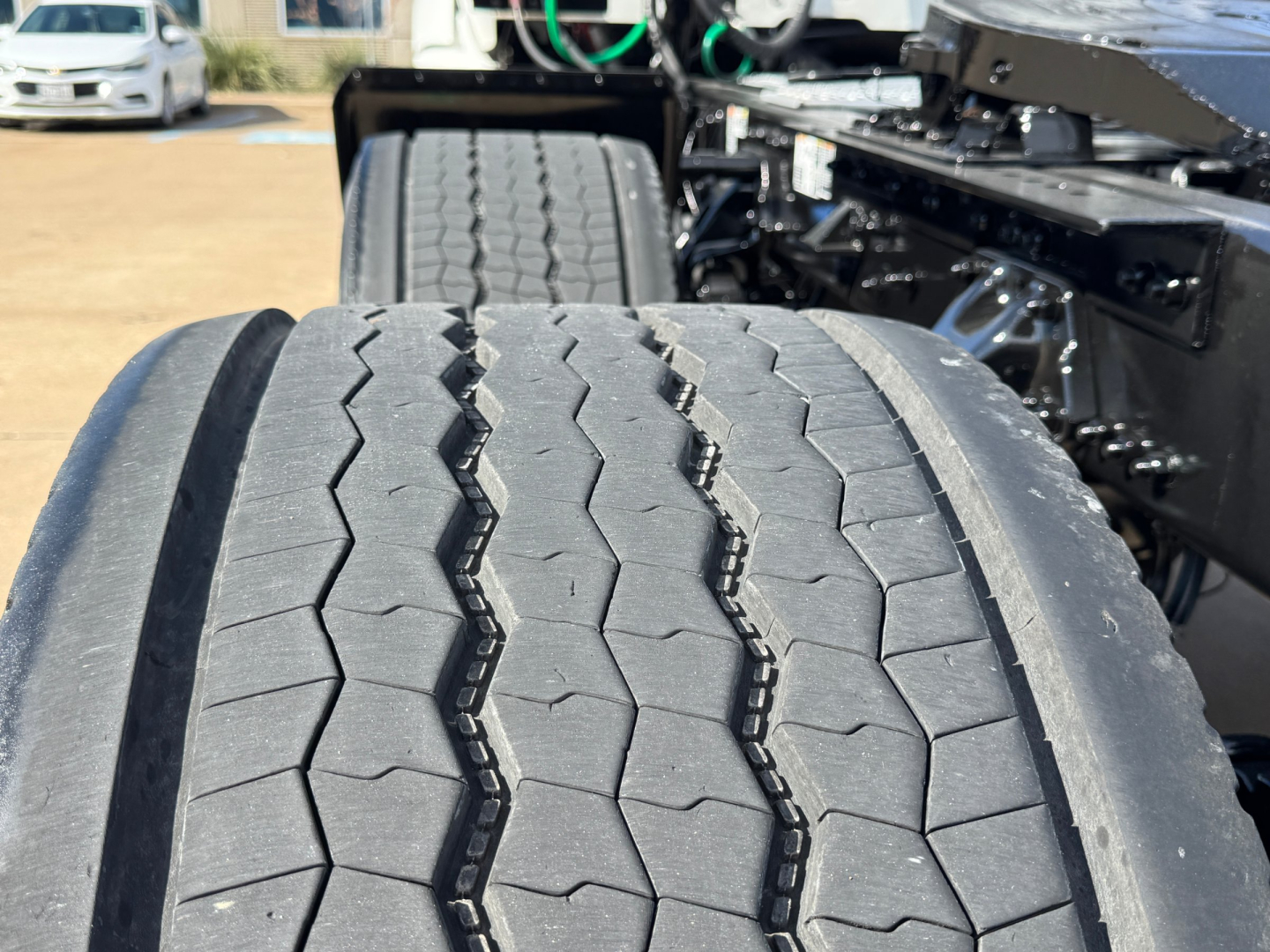 Kenworth T680 chassis with dual rear tires and large tread pattern; visible parts include truck frame and wheel assemblies.