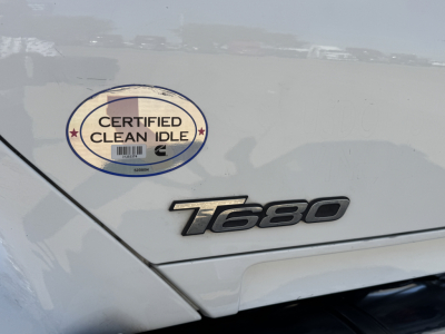 Kenworth T680 badge and Certified Clean Idle sticker on side panel showing T680 emblem.