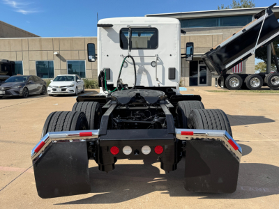 Kenworth T680 rear view showing chassis and mudflaps with hitch and hydraulic lines.