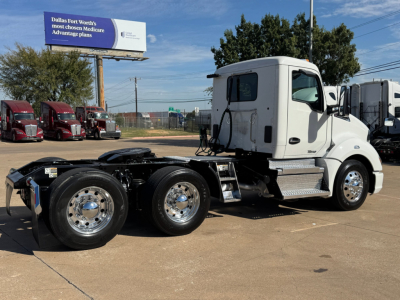 Kenworth T680 tractor unit side view with white cab and black chassis, dual rear axles, chrome wheels, and fuel/step area visible.
