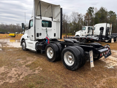 Kenworth T680 day cab tractor chassis showing rear wheels and fifth wheel with visible VIN and stock info on listing.