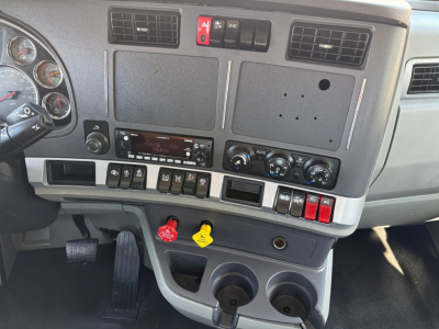 Dashboard area of a 2022 Kenworth T880 daycab showing instrument cluster, center console, and switches.
