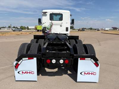 Kenworth T880 daycab tractor chassis rear view showing dual rear axles and MHC white mudflaps.
