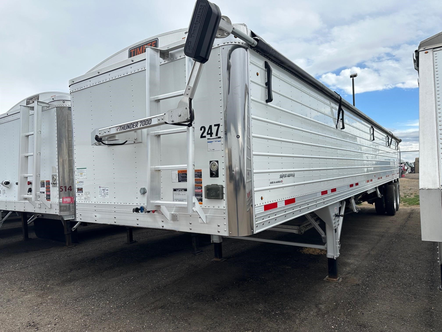 Timpte Super Hopper trailer in a used condition showing side paneling, front hitch, landing gear, and rear entry with reflector lights.