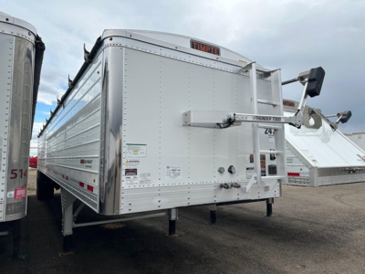 Timpte Super Hopper trailer showing side and rear with 'TIMPTE' logo and various decals on the front corner.