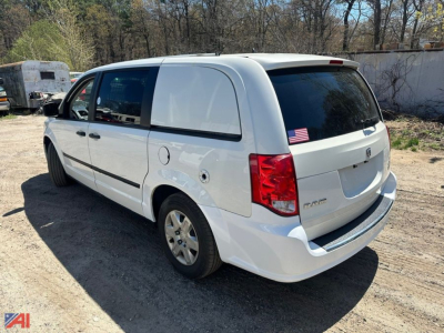 Cargo van showing rear and passenger-side in white, 2013 Dodge Ram, with rear hatch, taillights, and small American flag decal on rear window.