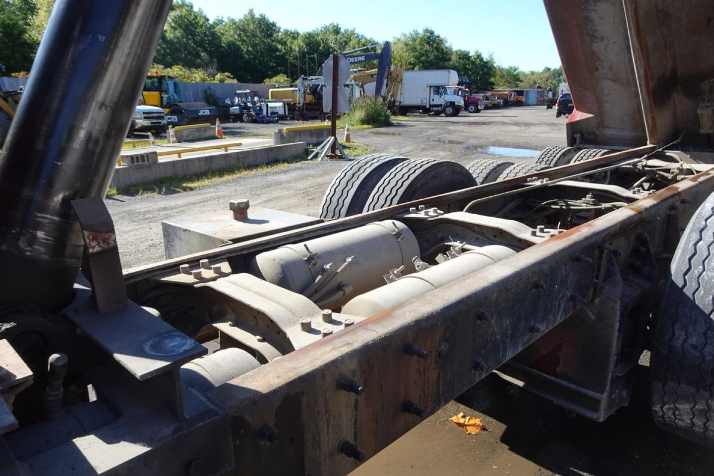 Chassis view of a 2004 Mack RD RD688S dump truck showing undercarriage, frame rails, and drivetrain components.