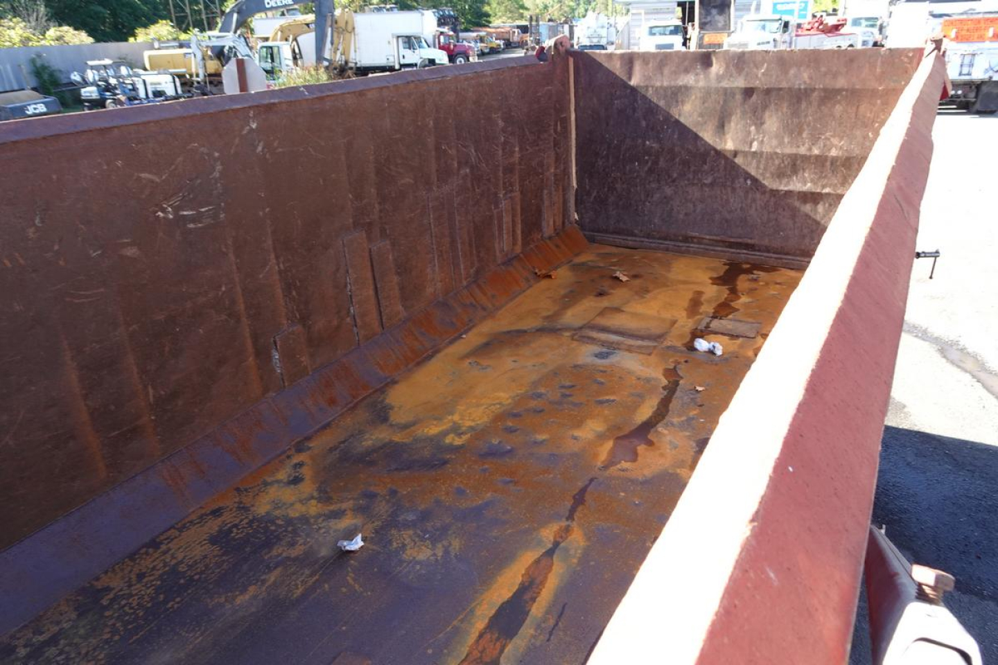 Dump truck bed interior showing rust-stained metal floor and tall steel sidewalls in a used 2004 Mack RD RD688S listing.