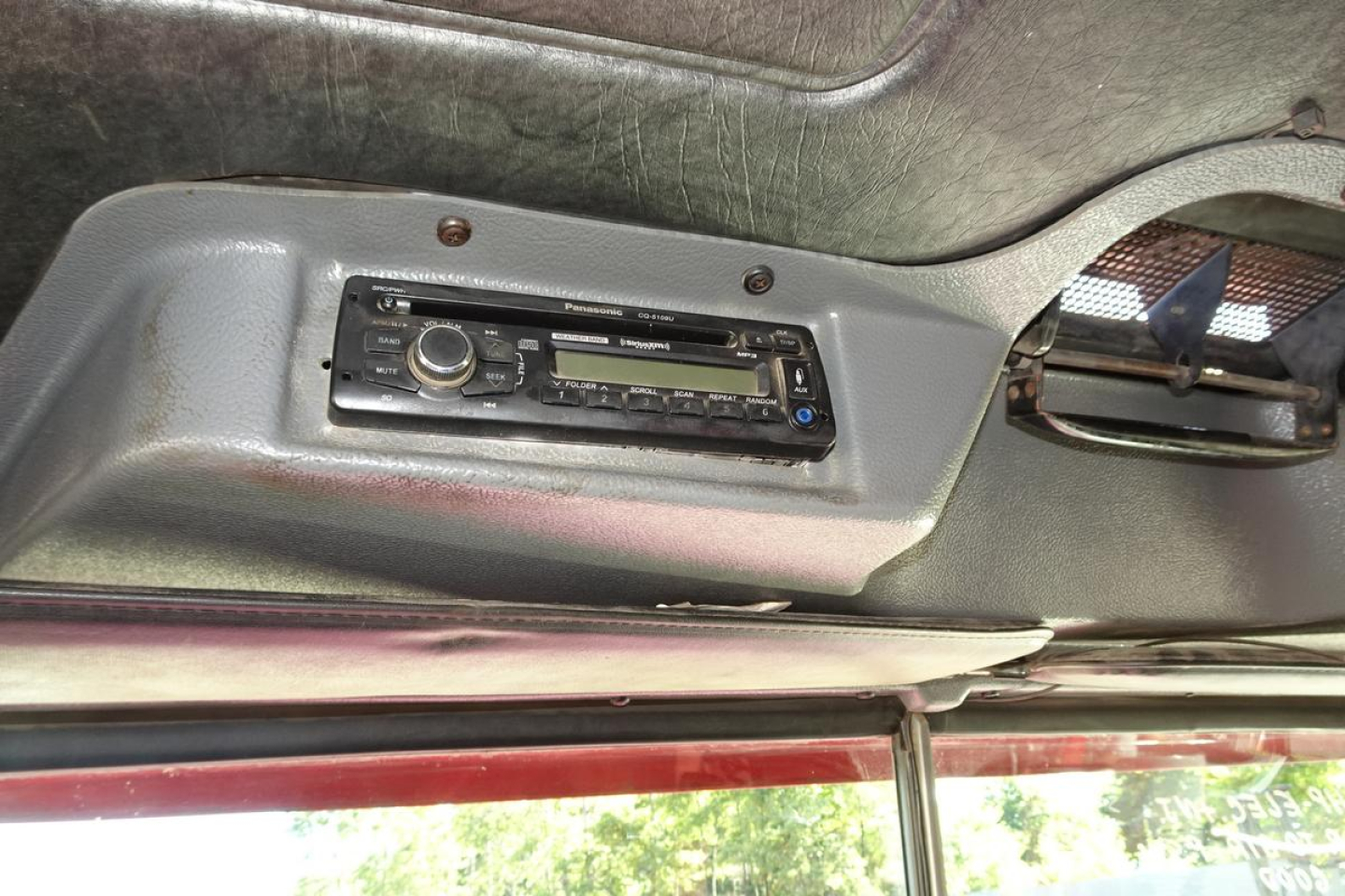 Mack RD688S truck dash area showing aftermarket radio head unit in the cab ceiling