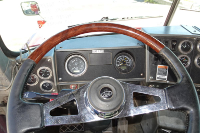 Mack RD RD688S truck dashboard and steering wheel with analog gauges.