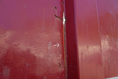 Mack RD RD688S dump truck component showing red-painted metal panels with a small white arrow mark.