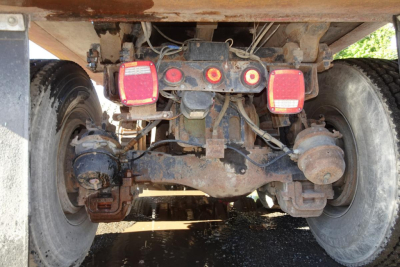 Rear axle of a Mack RD RD688S dump truck showing suspension, axle housings, differential, and taillights.
