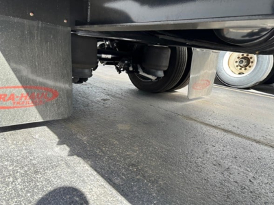 Trailer underside view of a 2026 Dura Haul 53' steel drop deck with beaver tail, showing undercarriage and wheels.
