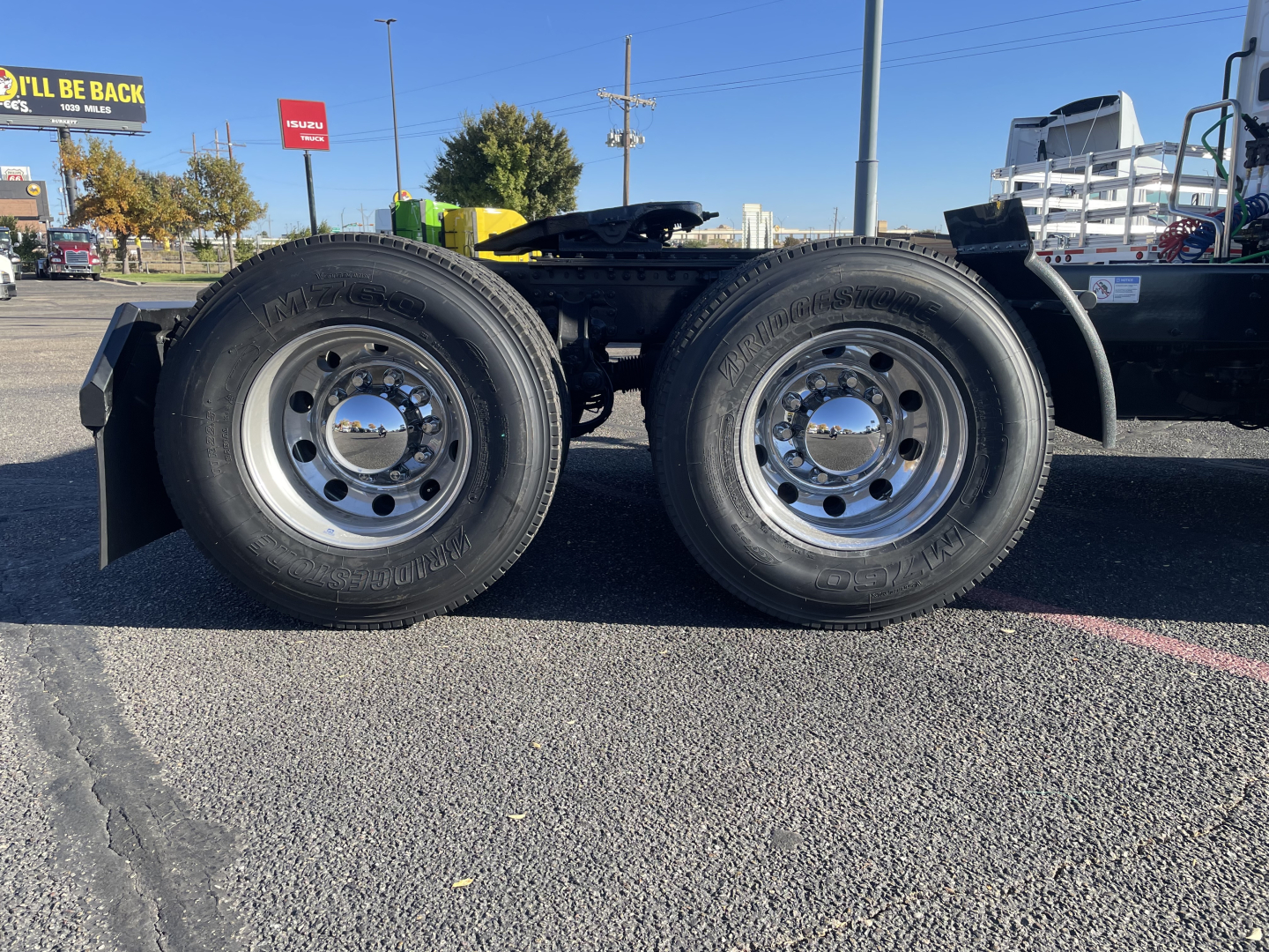 Mack PR64T truck chassis with dual rear axles shown in side view. Wheels and polished aluminum rims visible.
