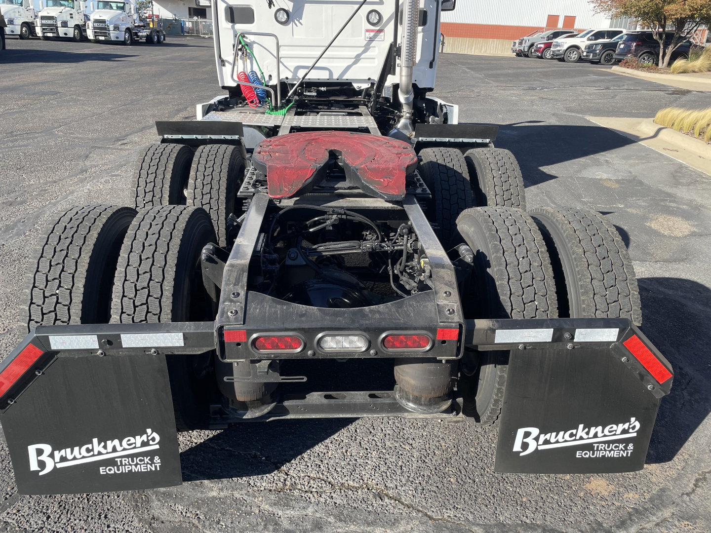 Rear view of a 2026 Mack PR64T tractor chassis showing dual rear axles, mud flaps with Bruckner's Truck & Equipment logo, and fifth-wheel area.