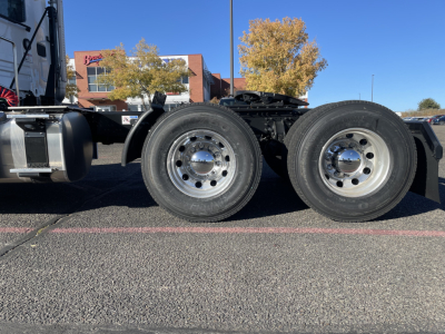 2026 Mack PR64T chassis showing dual rear axles with polished steel rims and tires in a parking lot.