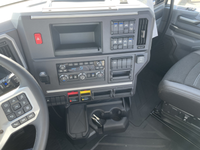 Mack PR64T truck dashboard showing control panels, buttons, and cup holders.