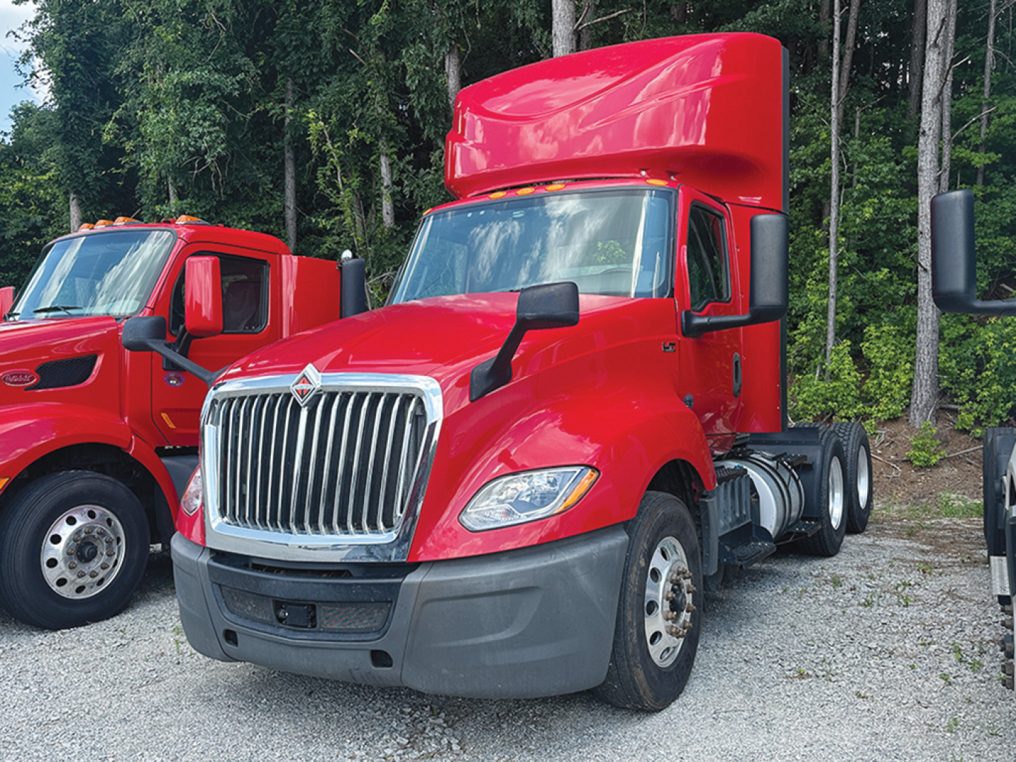 2019 International LT625 daycab truck shown in red with chrome grille and tall sleeper, front 3/4 view.