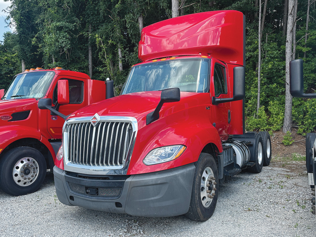 2019 International LT625 daycab truck shown in red with chrome grille and tall sleeper, front 3/4 view.