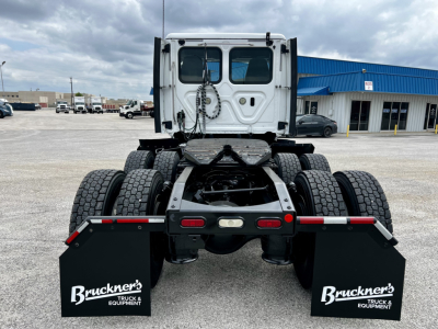 Rear view of a 2020 Freightliner Cascadia 126 tractor chassis showing dual rear axles, fifth wheel mounting, and mud flaps with Bruckner's branding.