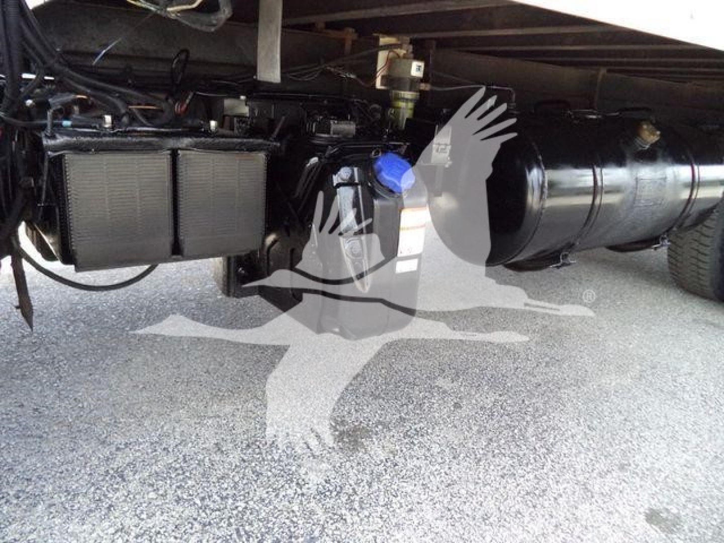 Underbody view of a 2019 Hino 195 refrigerated truck showing coolant reservoir, air intake duct, and fuel/air lines.