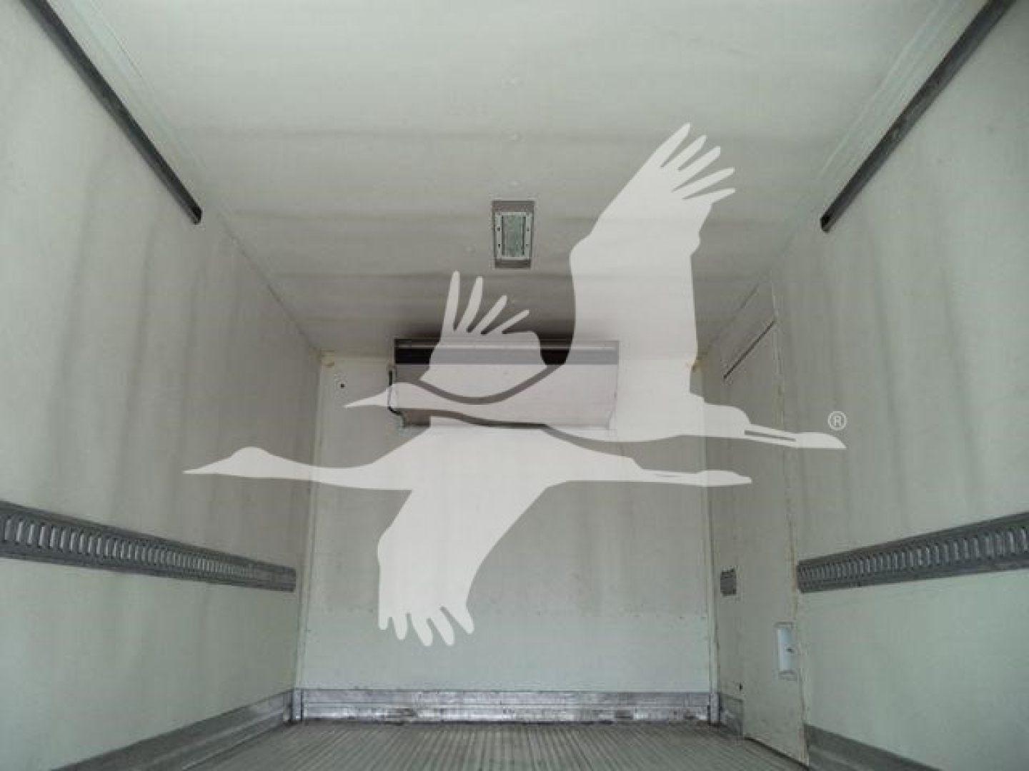 Truck refrigerated trailer interior cargo area with white seagull overlay