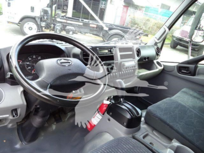 Cab interior of a 2019 Hino 195 refrigerated truck showing steering wheel, dashboard, center console, and driver's seat.