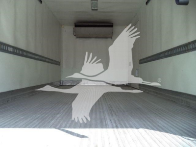 Interior of refrigerated truck cargo area with ribbed floor and ceiling-mounted unit; empty space.