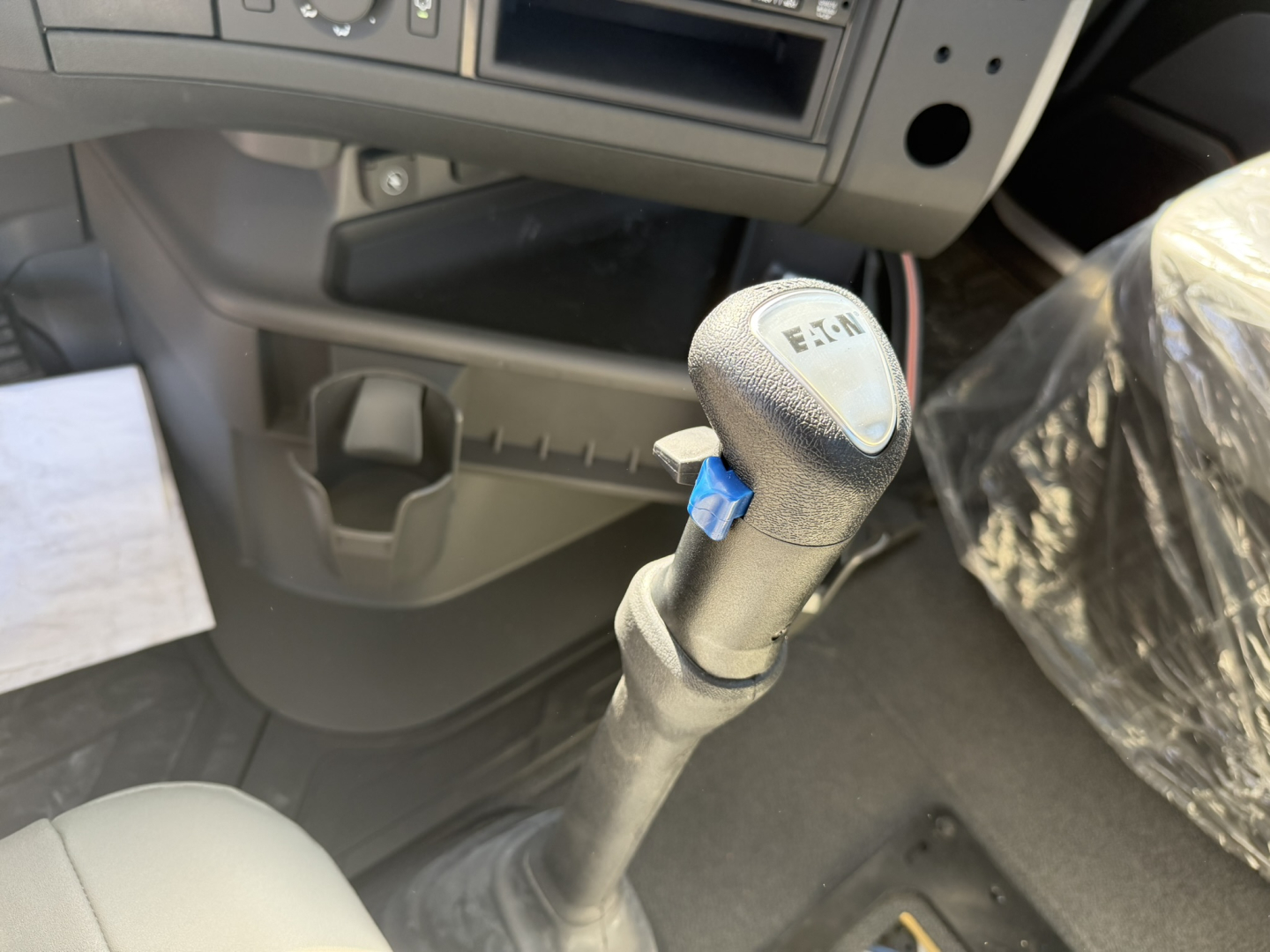 Volvo VHD86B300 cab and chassis interior showing gear shift lever with E-Tek label and surrounding controls.