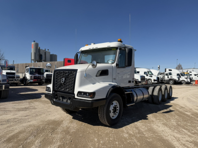 Volvo VHD86B300 cab and chassis truck in a dealership lot showing front grille, headlights, and 3-axle configuration with white cab.
