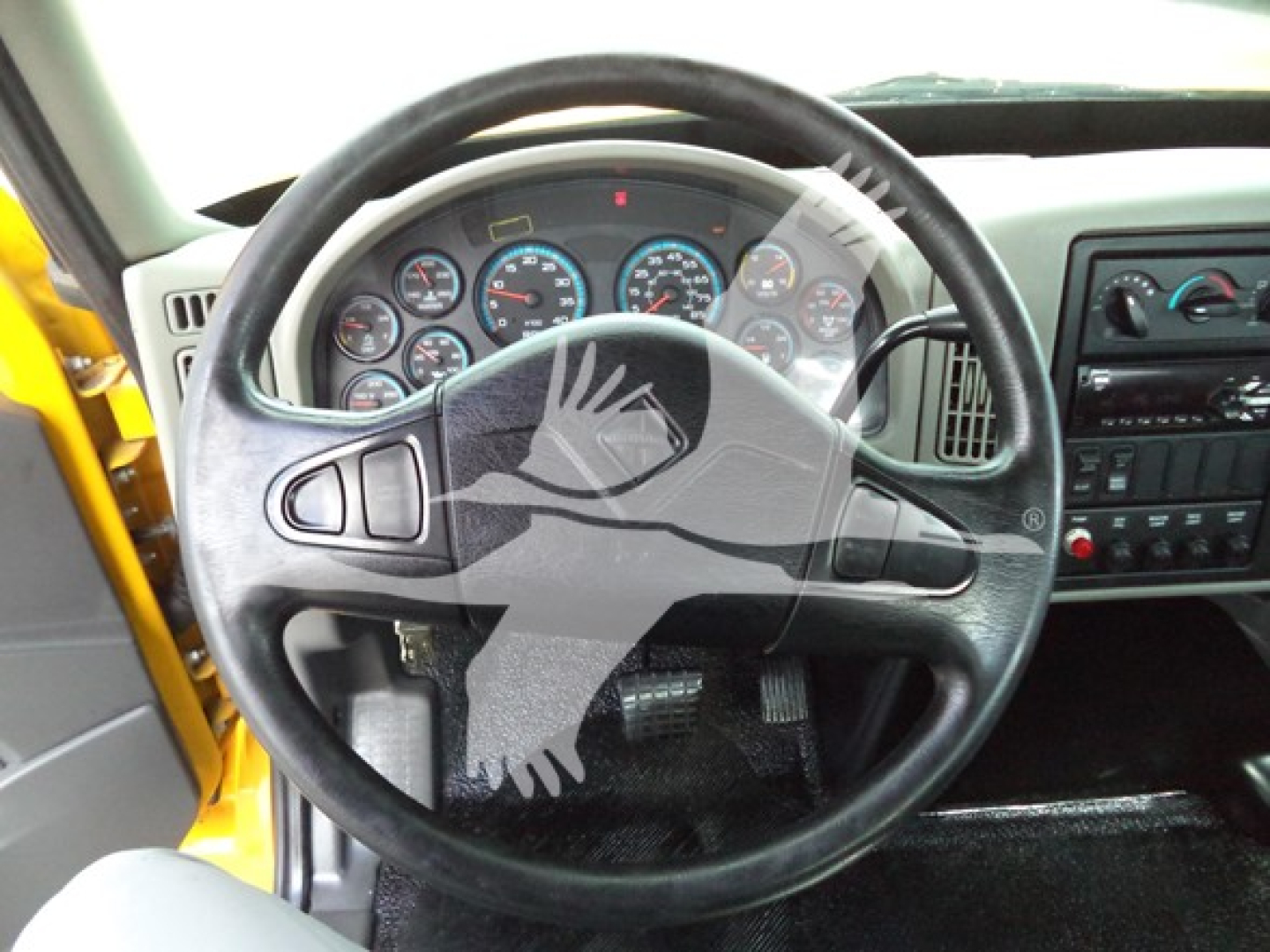 Truck cab interior showing steering wheel and instrument cluster of a 2019 International Durastar 4300 rollback truck.