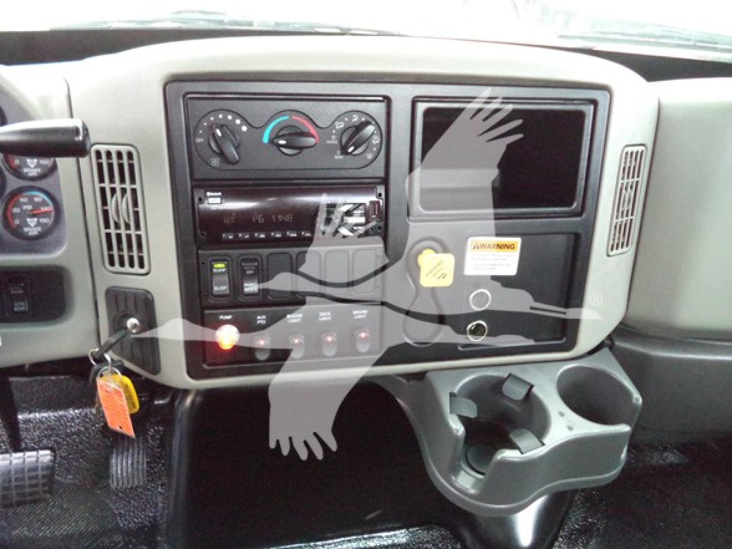 Dashboard of a 2019 International Durastar 4300 showing center control panel, air conditioning knobs, stereo, ignition, and cup holders