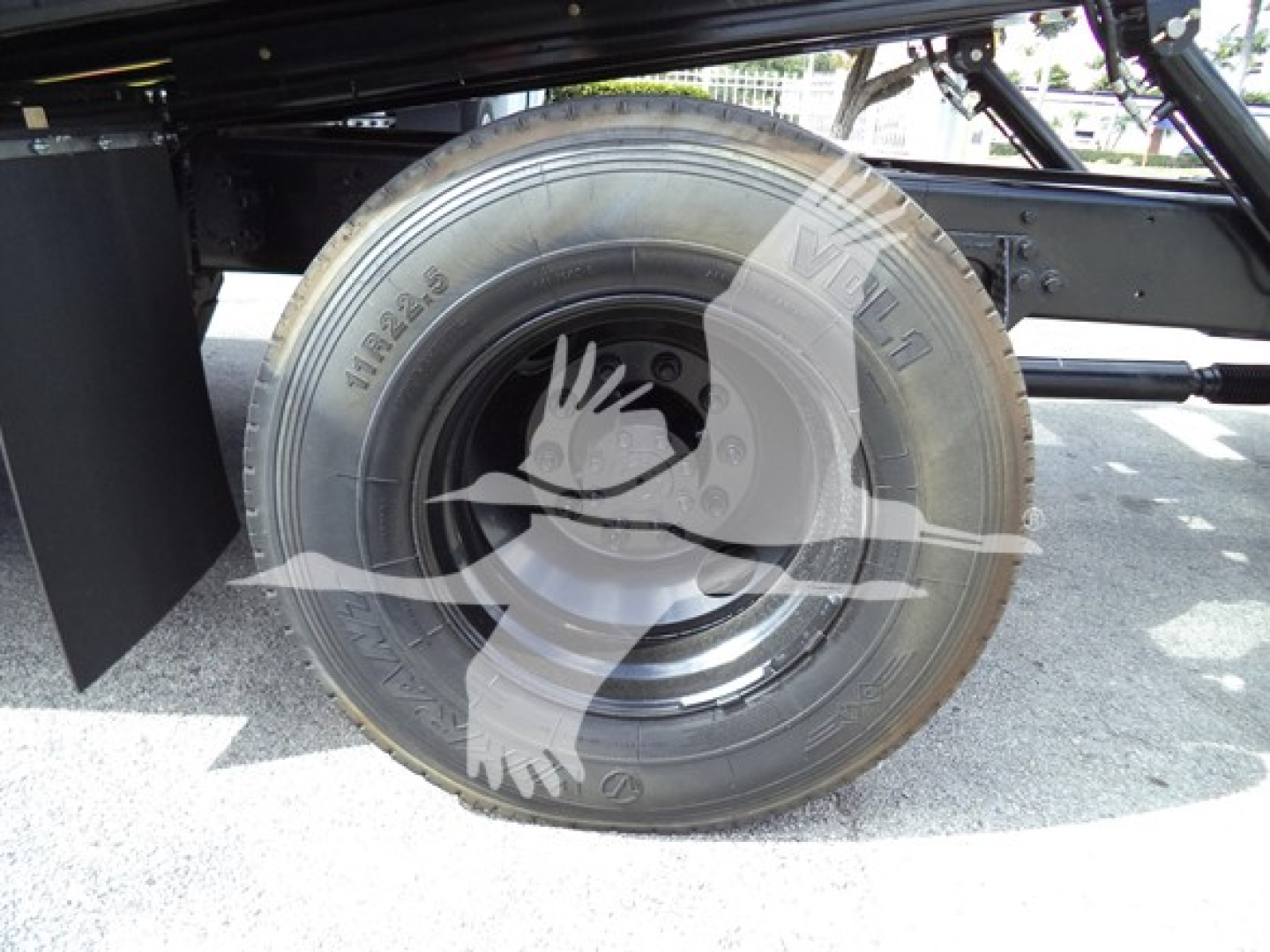 Truck rear wheel and suspension of a 2019 International Durastar 4300 rollback truck showing tire and wheel with visible branding.