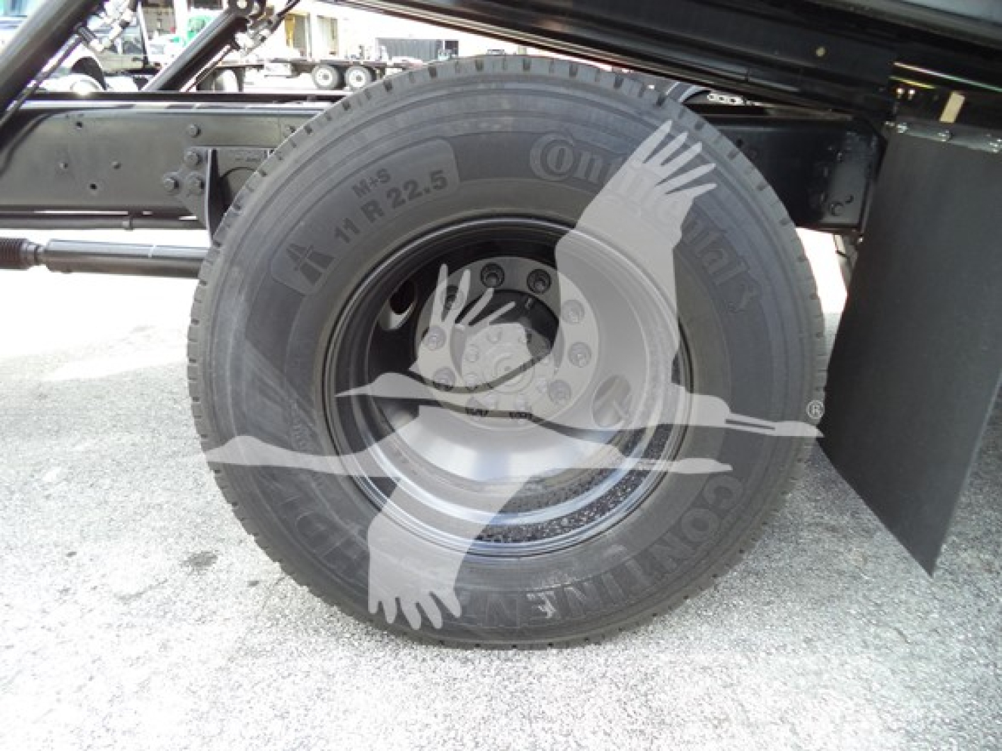 Truck wheel hub and tire on a 2019 International Durastar 4300 rollback chassis showing Continental tire with rim and rear fender.